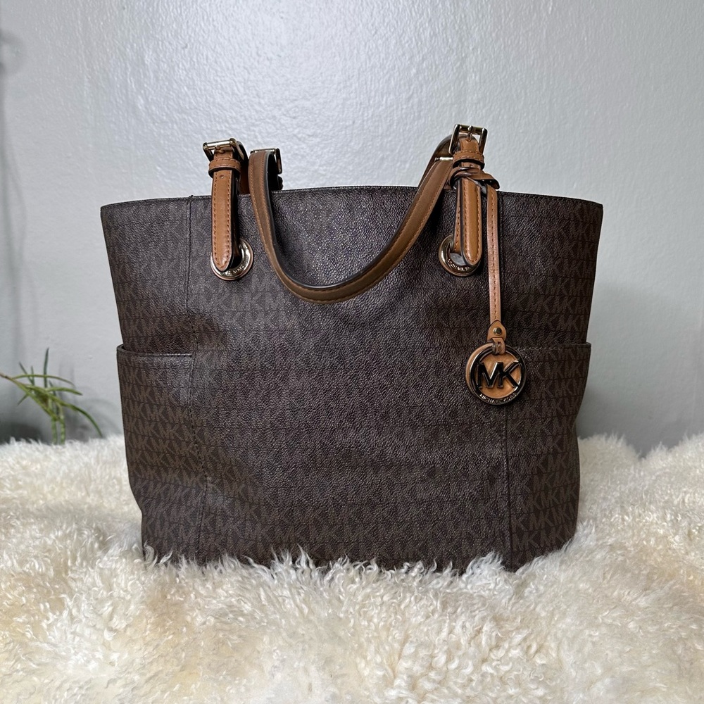 Classic Micheal Kors monogram travel tote bag with two side pockets